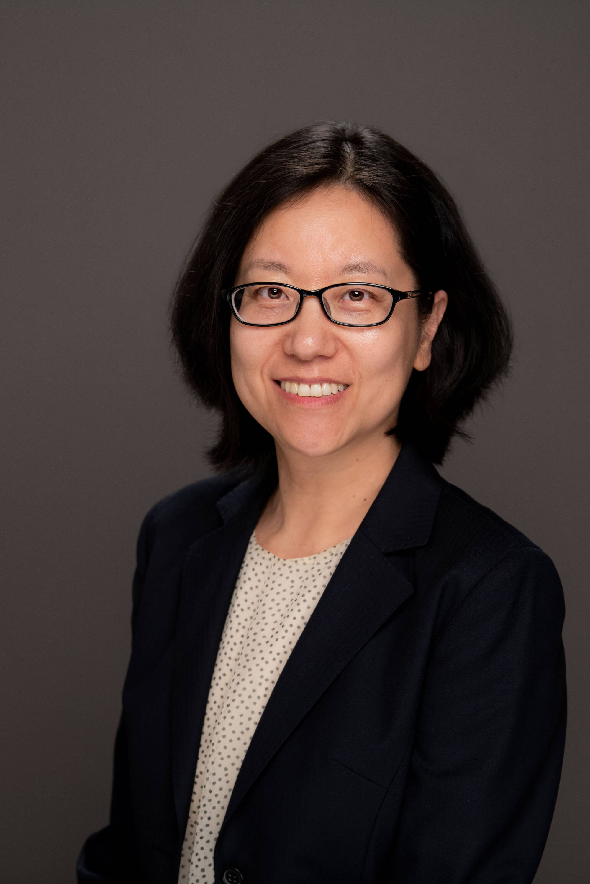 Portrait of Jie Du on a dark gray background